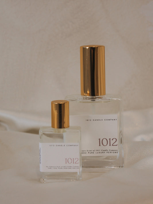 Two luxury organic perfumes in various size, clear glass bottles with gold tops by 1012 Candle Co