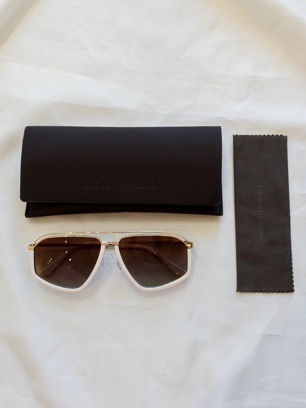 White oversize aviator sunglasses with chocolate brown case and cleaning cloth