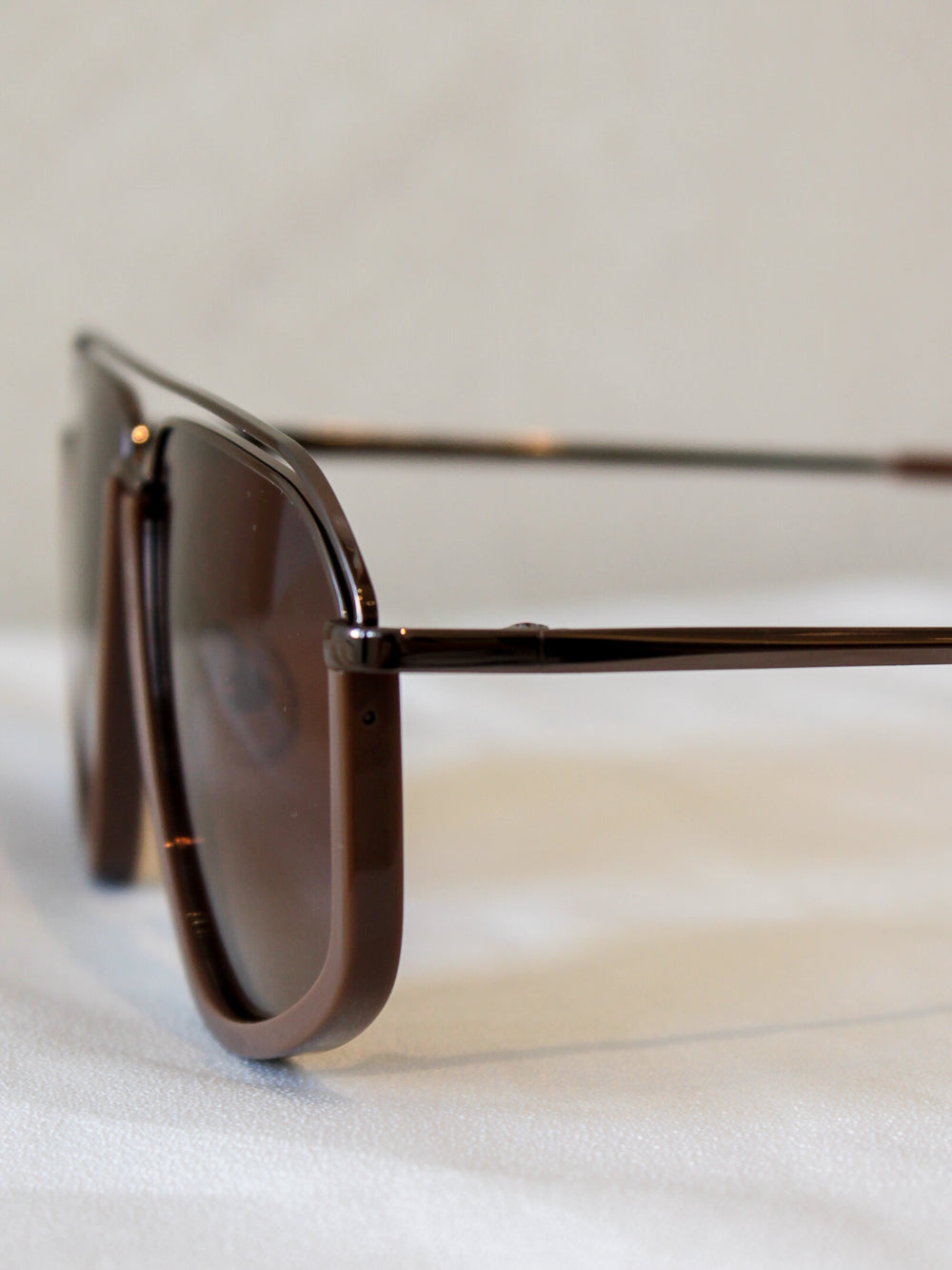Oversized aviators with a brown frame, matching brown brow bar and metal arms