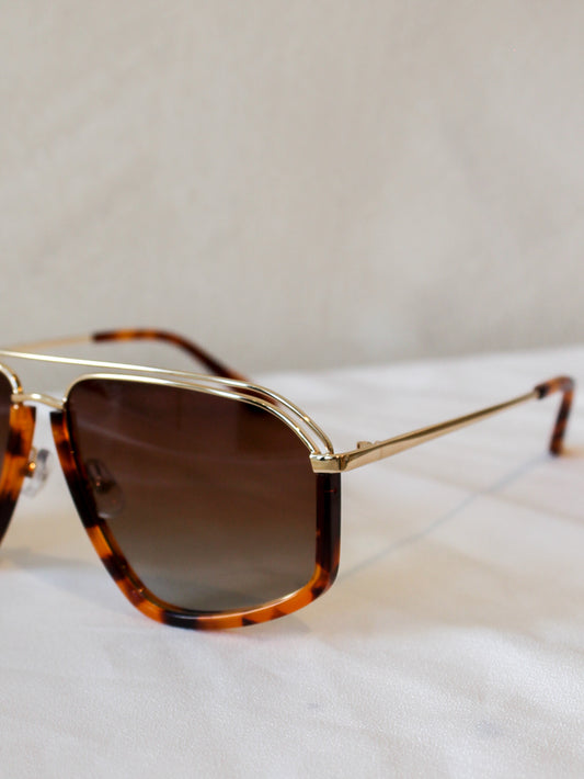 Sunglasses with tortoiseshell frame and brown lenses and gold accents