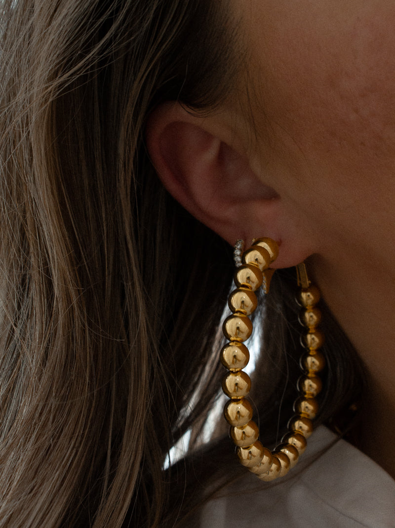 Girl wearing big hoop earrings