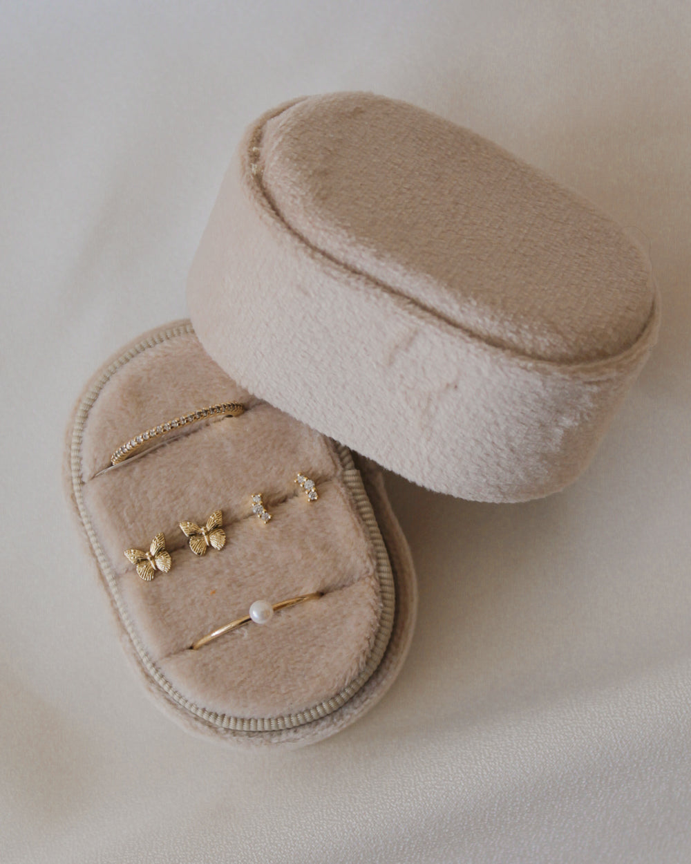 Gold jewelry in a small velvet jewelry holder