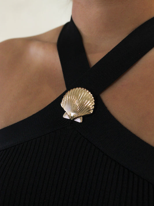 Black halter dress with a gold seashell detail
