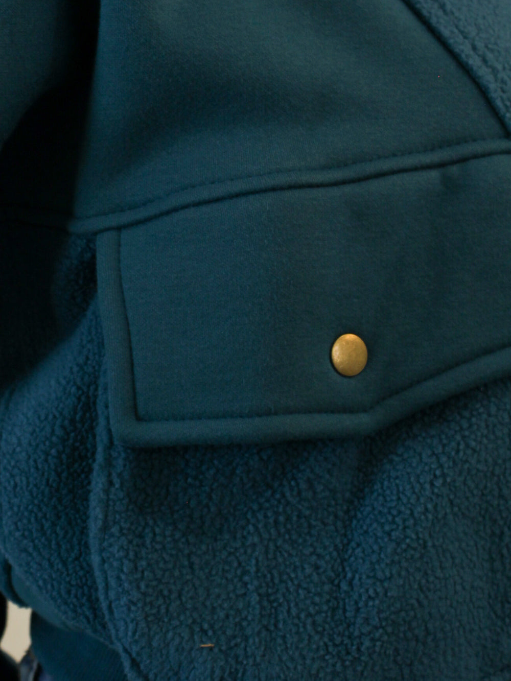 Detail view of teal pullover sweat shirt