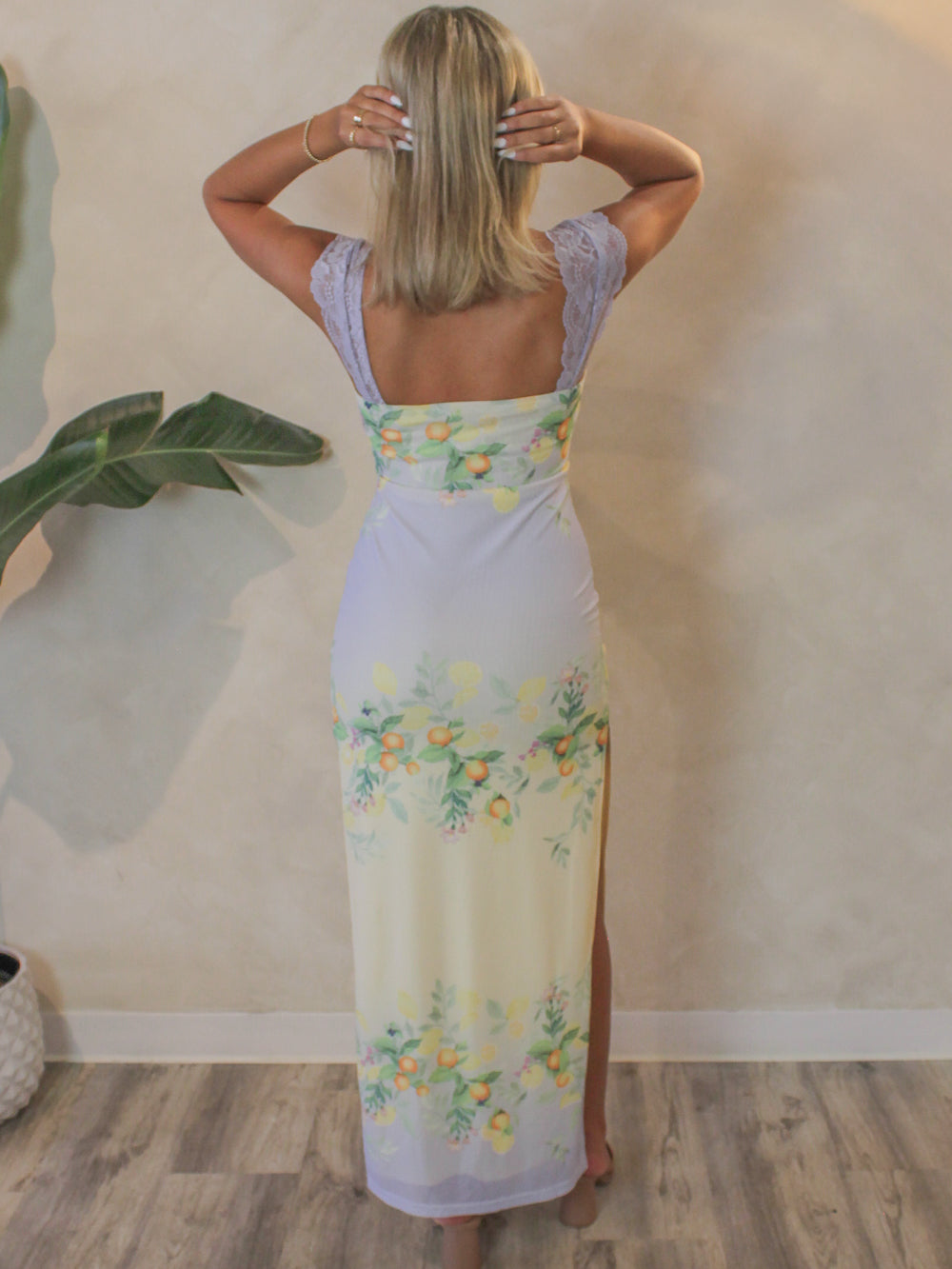 Back view of a lemon print dress made from a comfortable mesh fabric
