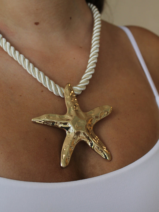 Gold starfish pendant on a white rope necklace