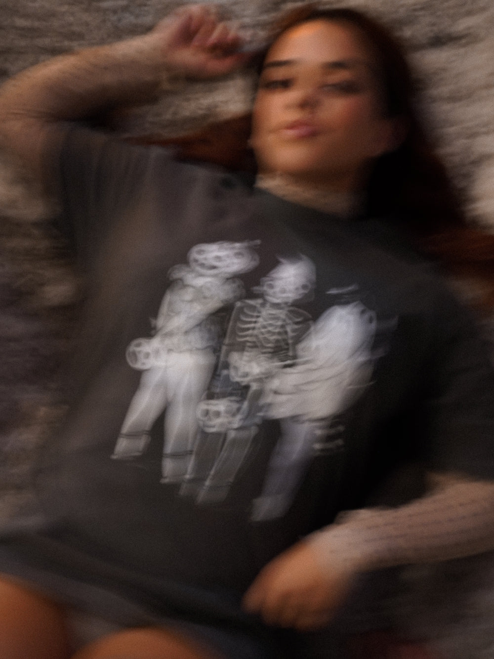 Woman wearing a vintage halloween tee with three ghoulish girls in halloween costumes