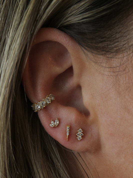 Ear stack with tiny gold stud earrings