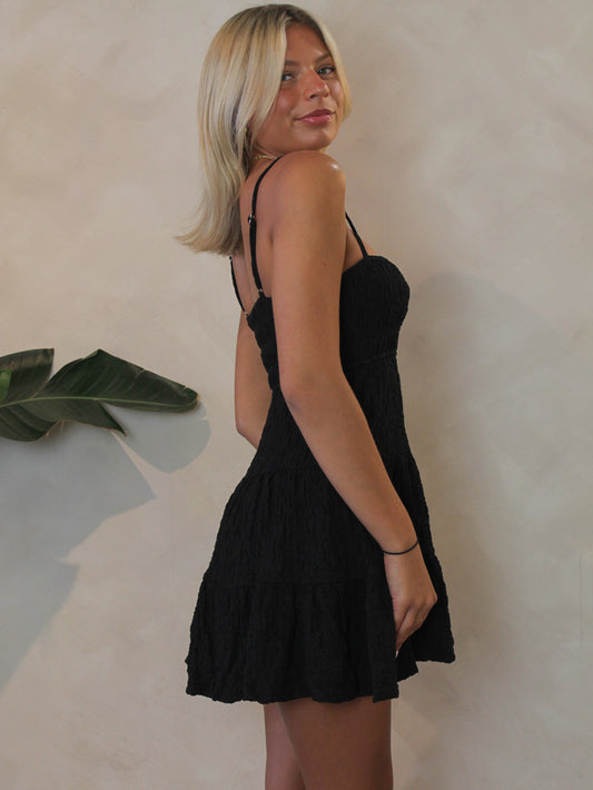 Le Lis black smocked mini dress with adjustable straps for warm summer days