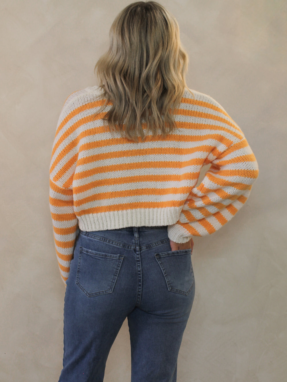Orange and white stripe sweater with blue denim