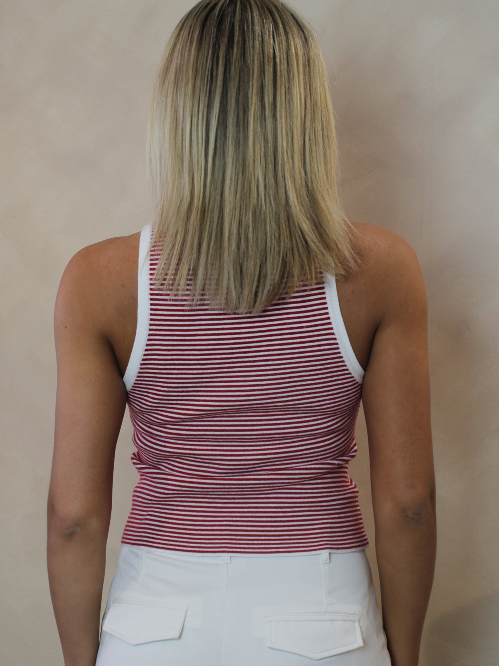 Woman wearing a white and red striped tank top outfit for Memorial Day or Fourth ofJuly.