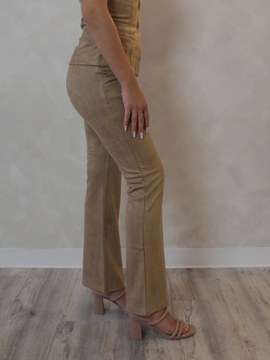 Woman wearing camel colored suede, flared pants