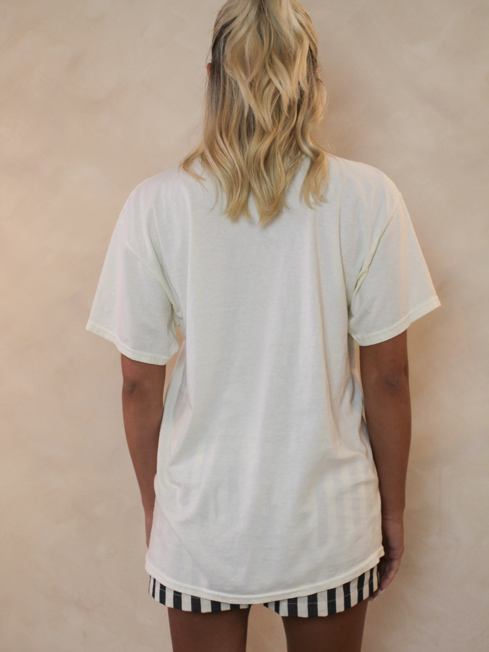Back view of a limoncello graphic tee on a model