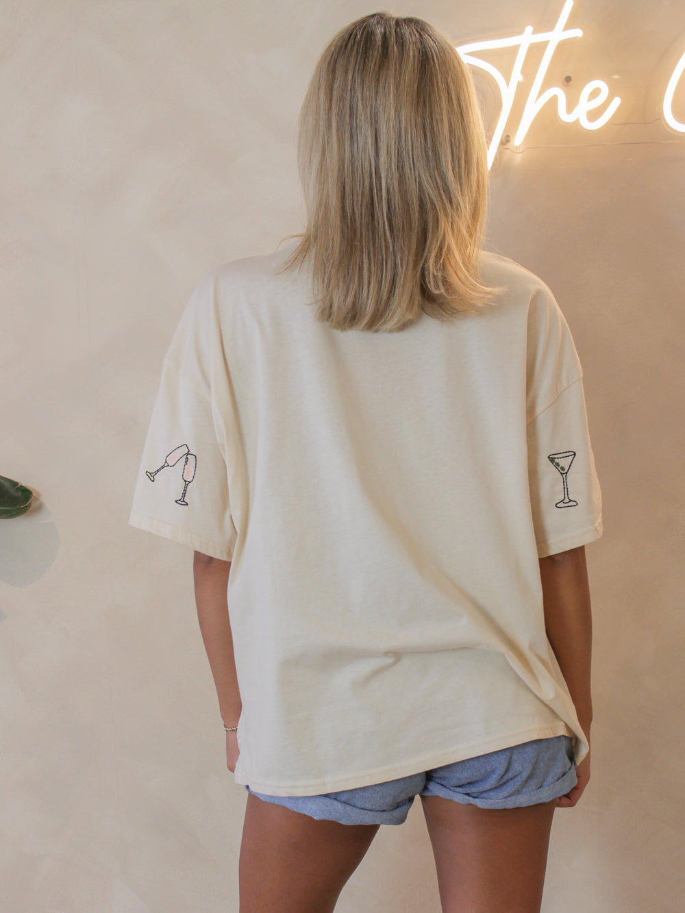 Oversized tee for women with embroidered cocktail graphics on the sleeves