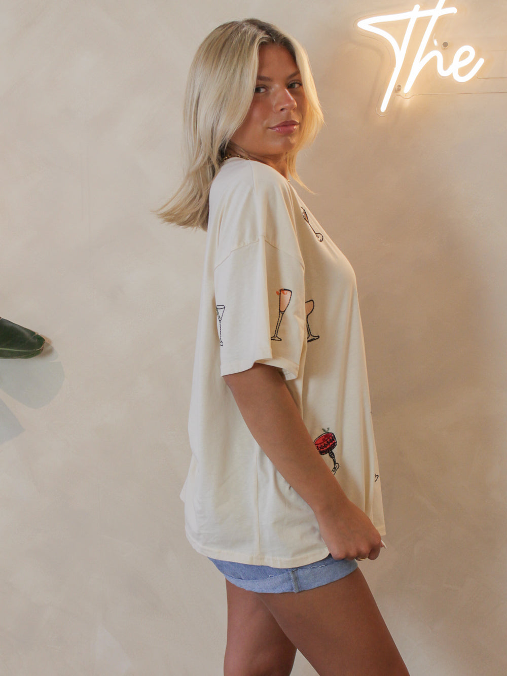 Side view of an oversized tee with cocktail graphics all over