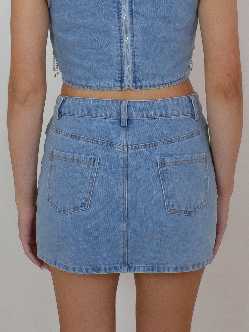 Denim mini skirt with rhinestone fringe details 