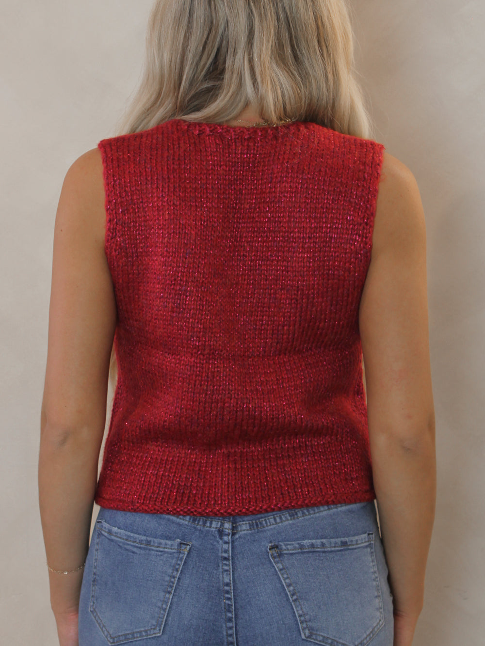 Woman wearing a red knitted vest