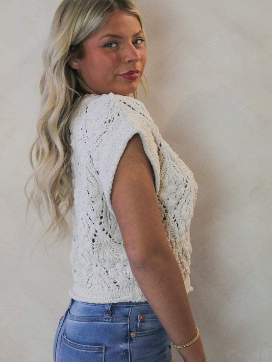 Model wearing a light grey short sleeve knit sweater