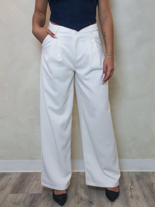 woman wearing wide leg, white trouser pants.
