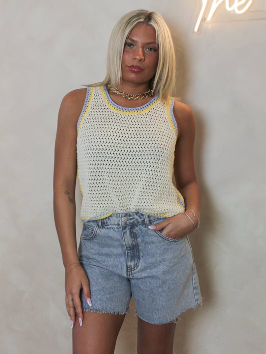 a butter yellow knit tank styled with denim shorts for spring.
