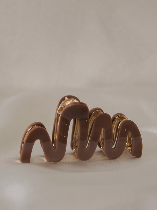 chocolate brown claw clip with a wavy design for women