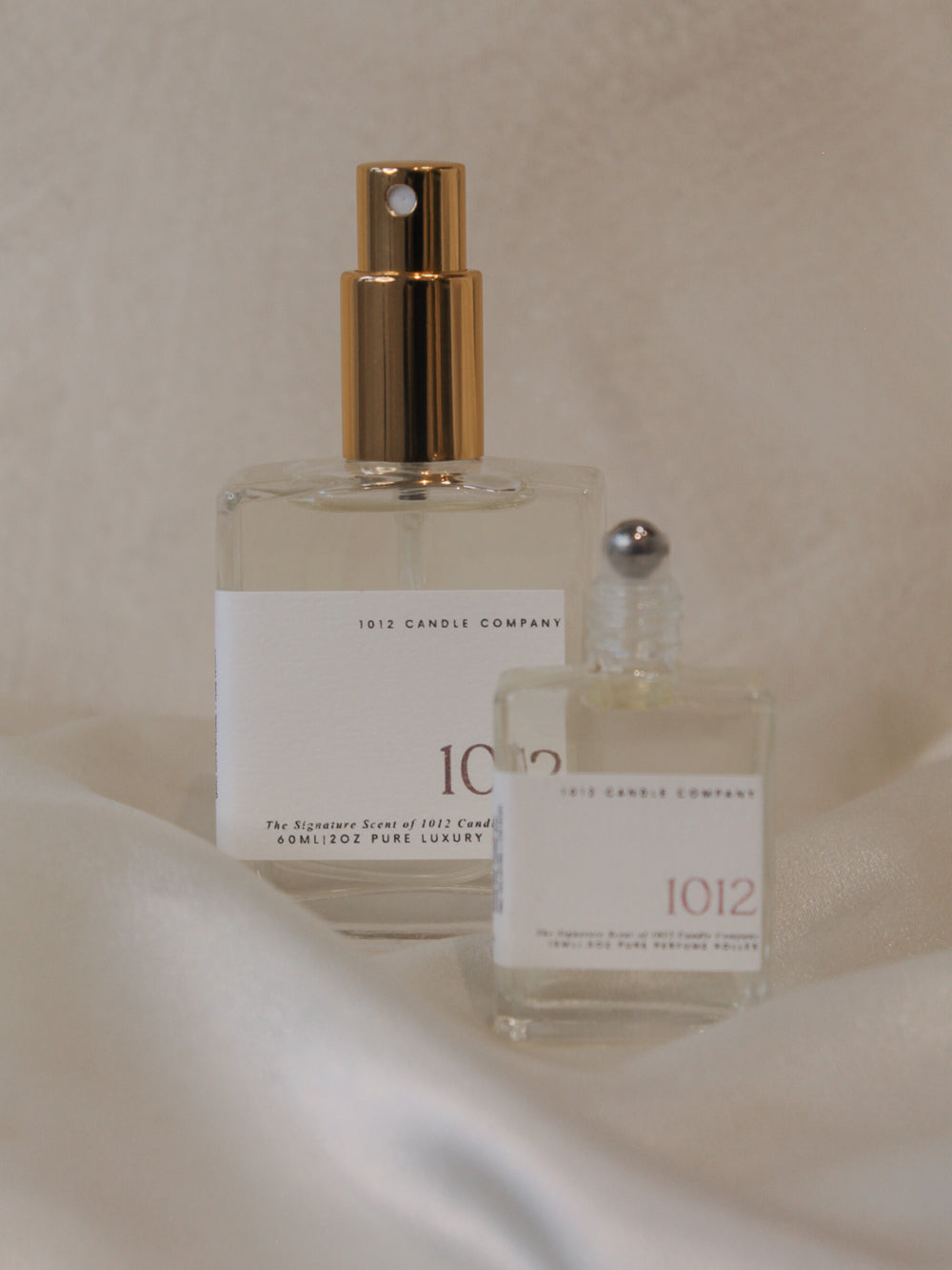 Two 1012 perfume bottles in various sizes, showing one with a spray top and one with a roller top 