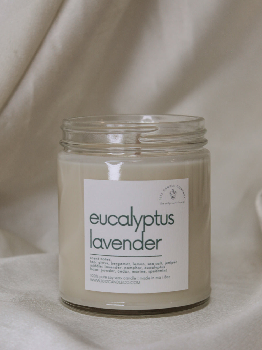 a eucalyptus lavender scented candle in a clear glass jar by 1012 candle co 