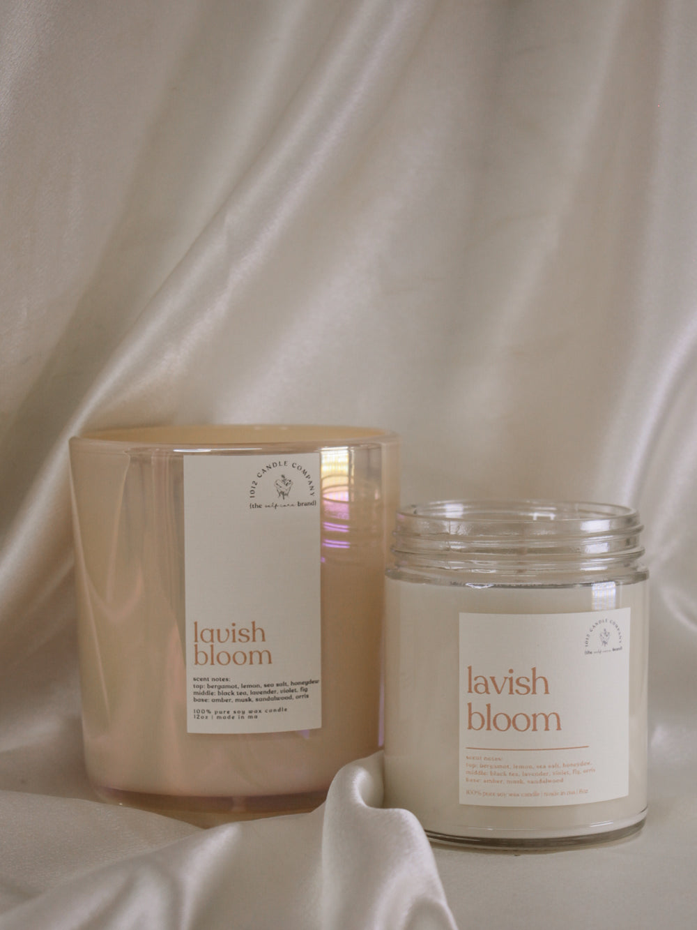 Two spring scented candles called lavish bloom in a 12oz iridescent vessel and an 8oz clear vessel