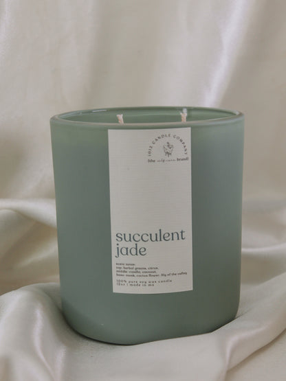 A soy wax candle in a matte sage green vessel in the scent succulent jade by 1012 candle co 