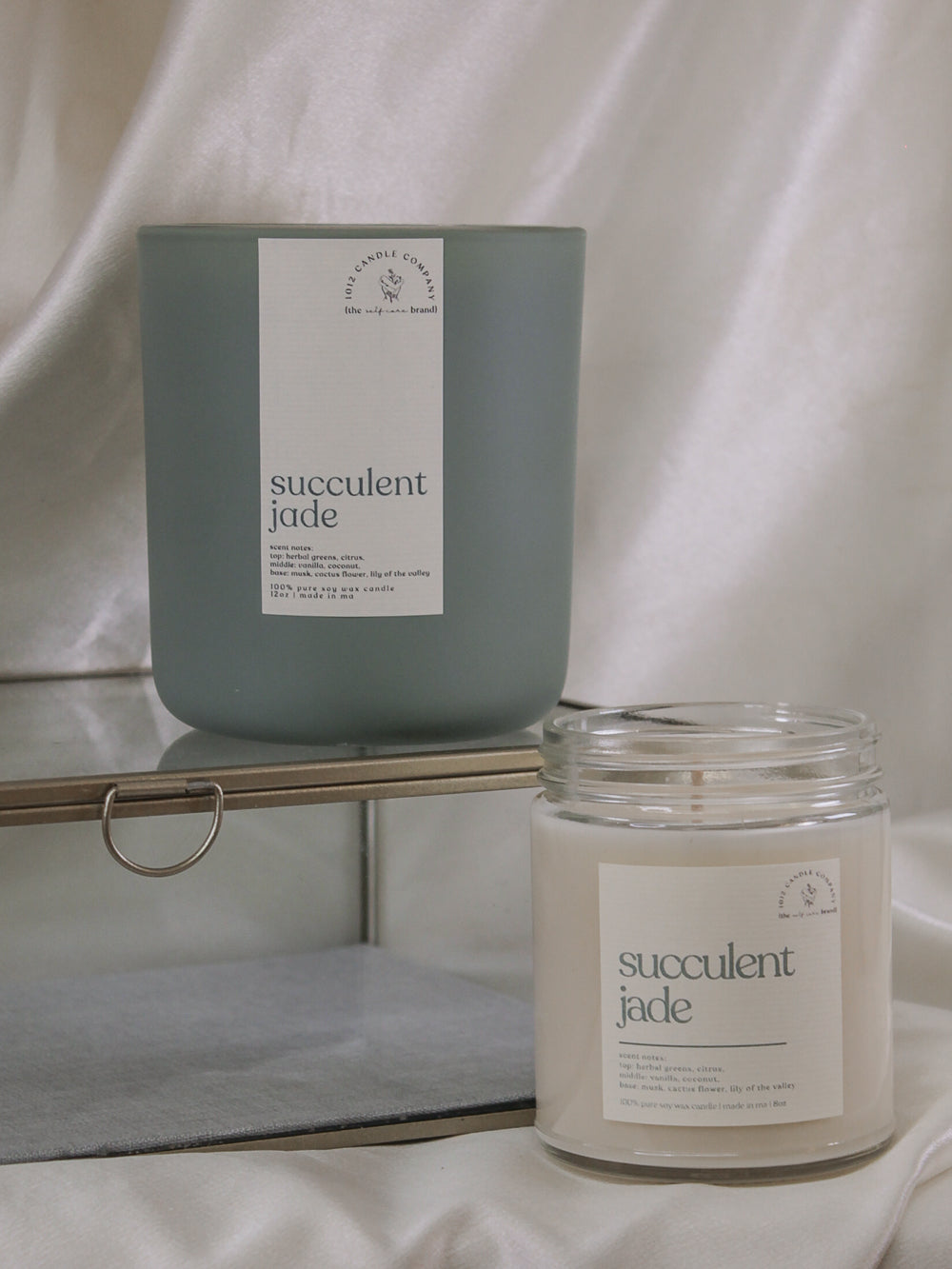 Two succulent jade, soy wax candles in an 8oz clear jar and 12oz sage vessel 