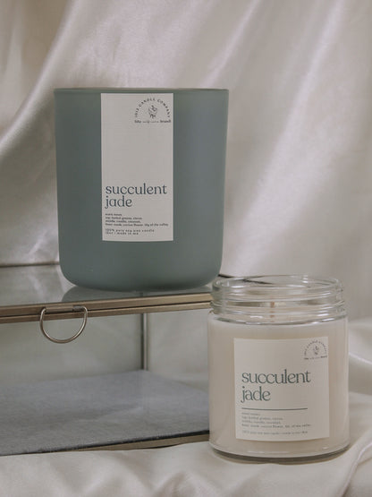 Two succulent jade, soy wax candles in an 8oz clear jar and 12oz sage vessel 