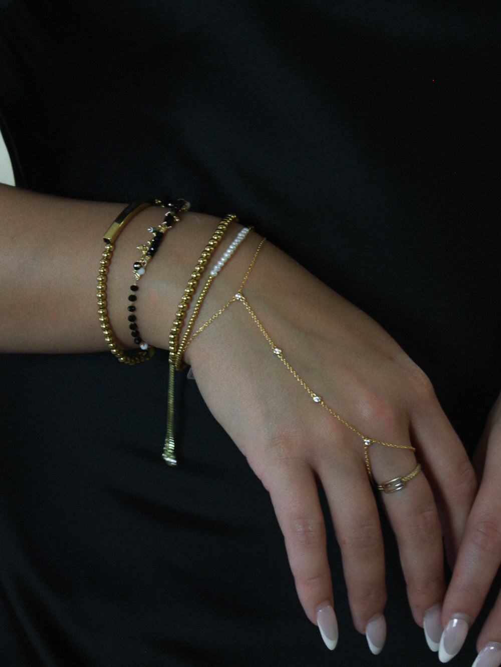GOLD BLACK AND BEADED BRACELET STACK 