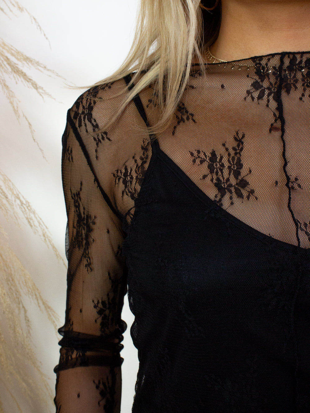 A cute, black , lace top with built in tank for women 