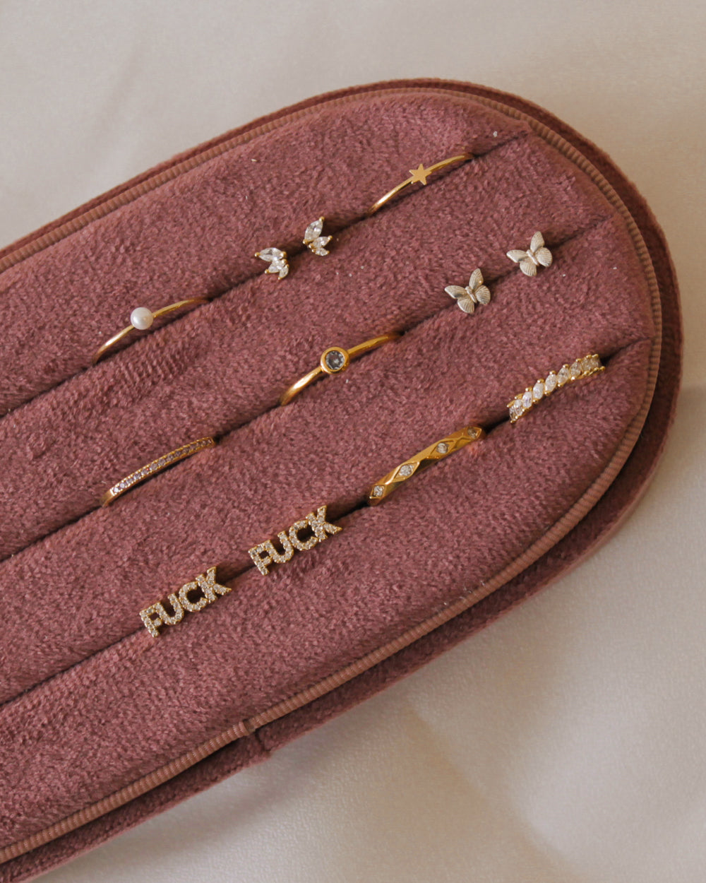 Gold dainty jewelry in a velvet jewelry box 