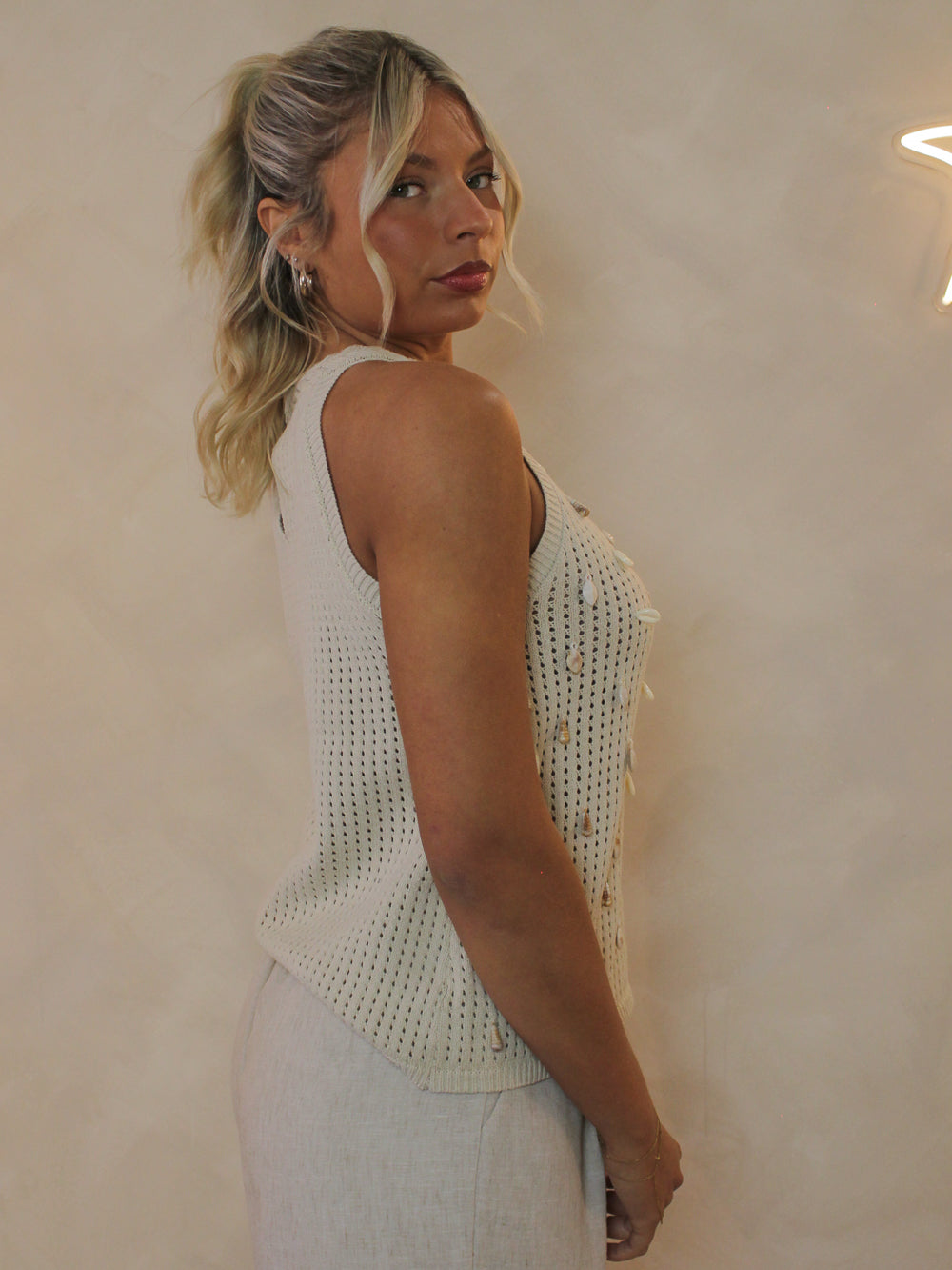 woman wearing a neutral crochet tank