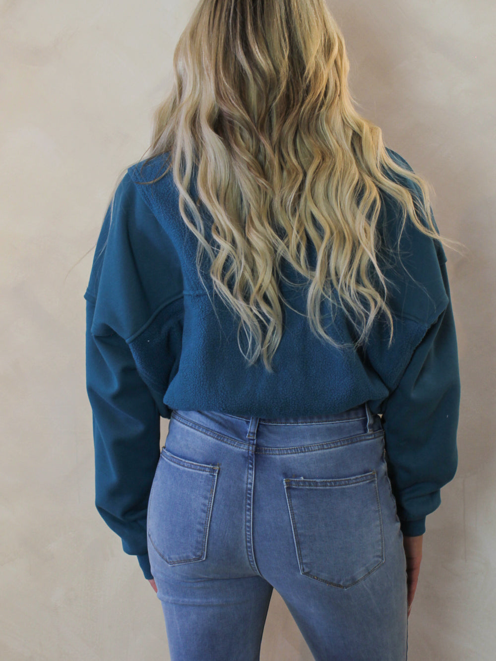 Back view of a womens teal pull over sweatshirt 