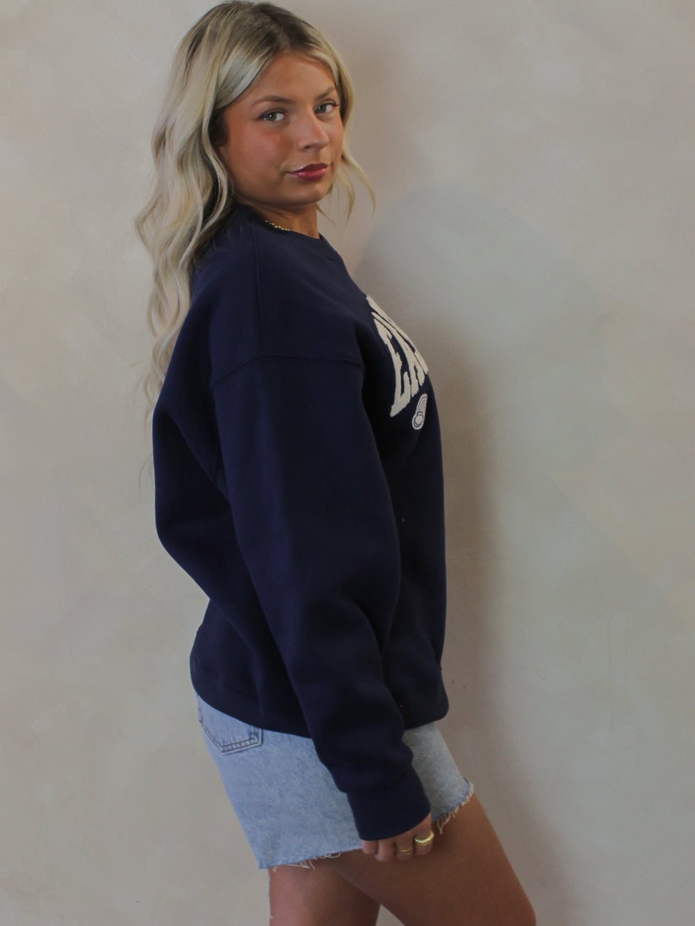 Model wearing a navy blue East Coast Sweatshirt 