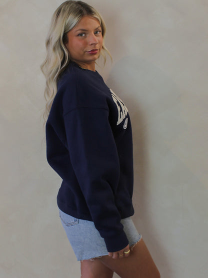 Model wearing a navy blue East Coast Sweatshirt 