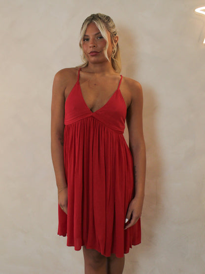 Woman wearing a short red, summer dress