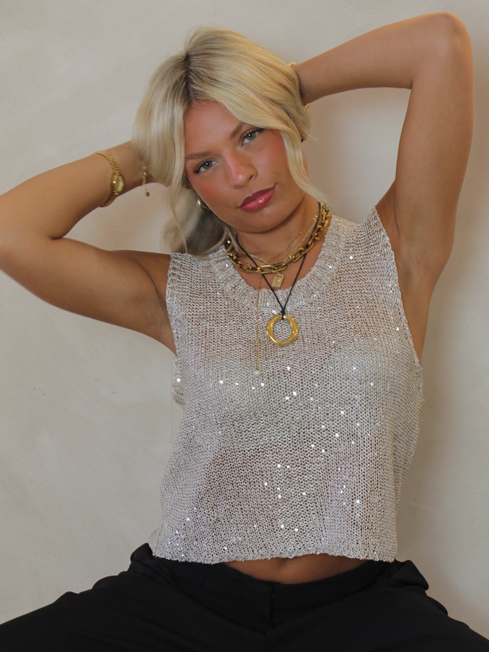 Woman wearing a shimmering sequin knit top 