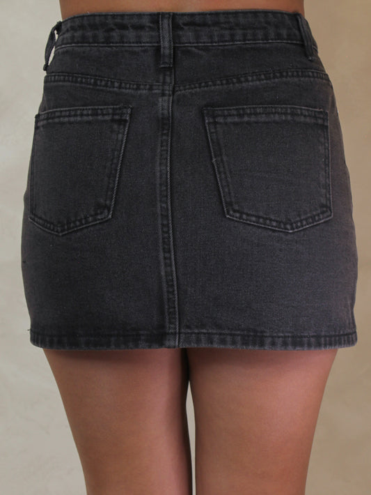 Black denim mini skirt.