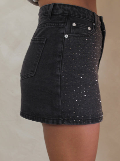 Black mini skirt with rhinestones all over the front.