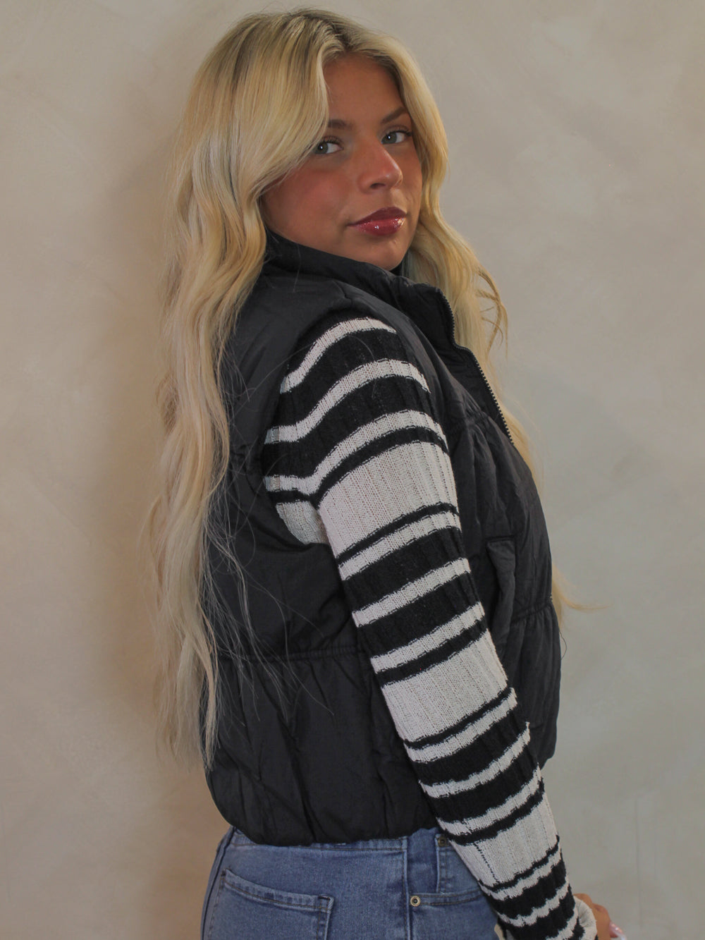 Woman wearing a black cropped puffer vest for fall and winter 
