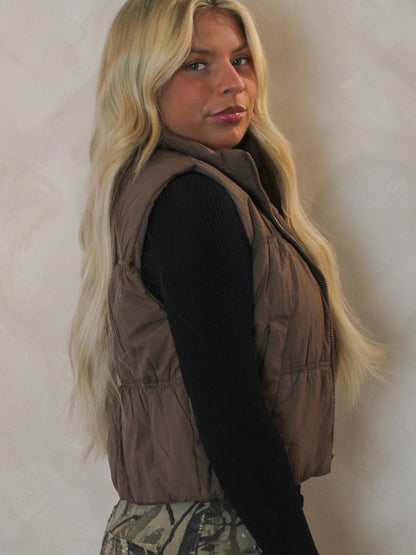 Model wearing a brown cropped puffer vest 