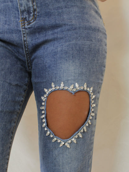Medium wash denim with heart cutout and rhinestone details 