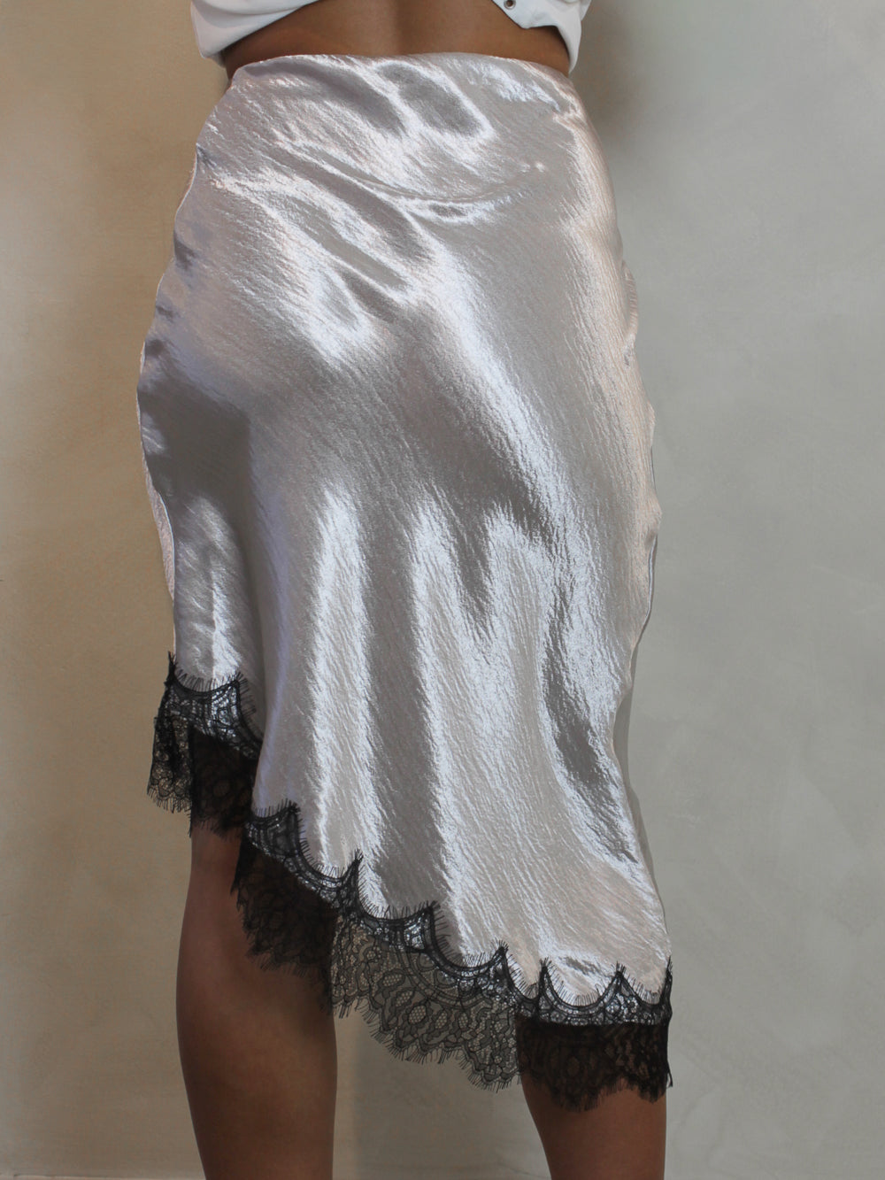 Silver midi skirt with an asymmetric hem.