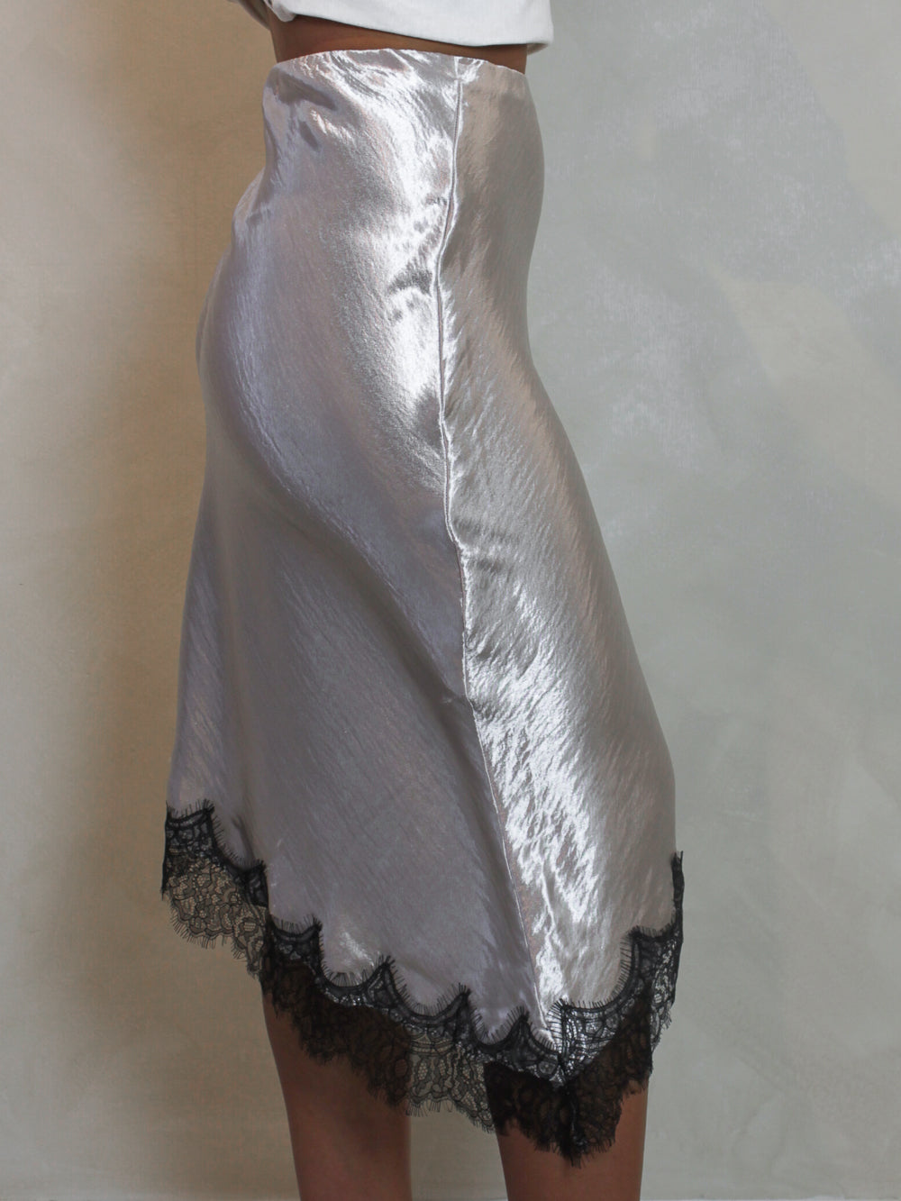 Silver metallic skirt with black lace trim.