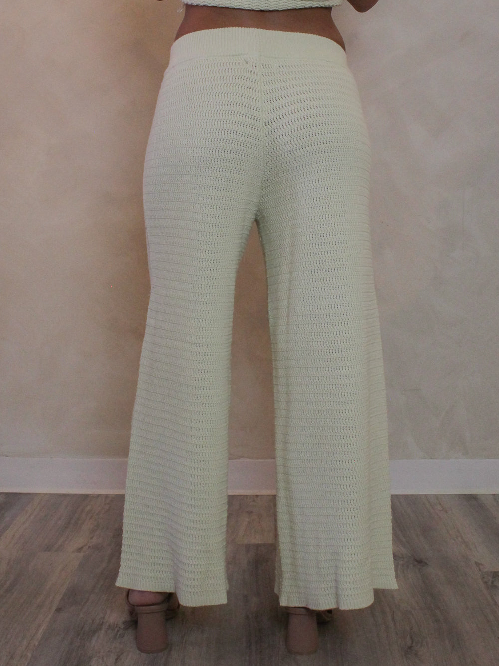 Back view or light green knit pants for woman