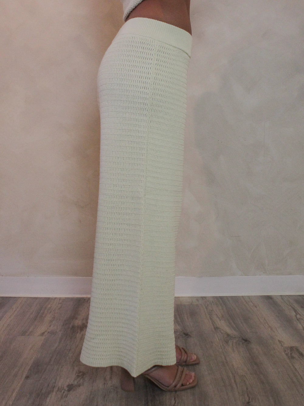 Woman wearing wide leg light green knit pants.