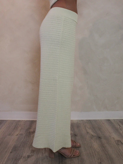 Woman wearing wide leg light green knit pants.